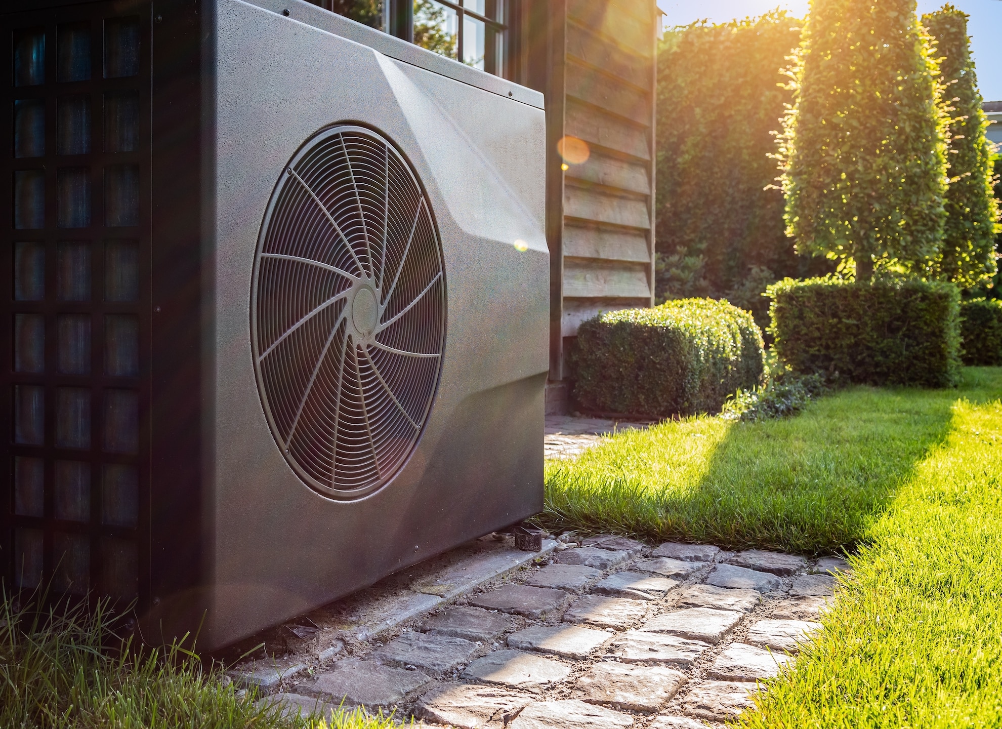 air heat pump for cooling and heating home outside on sunny day