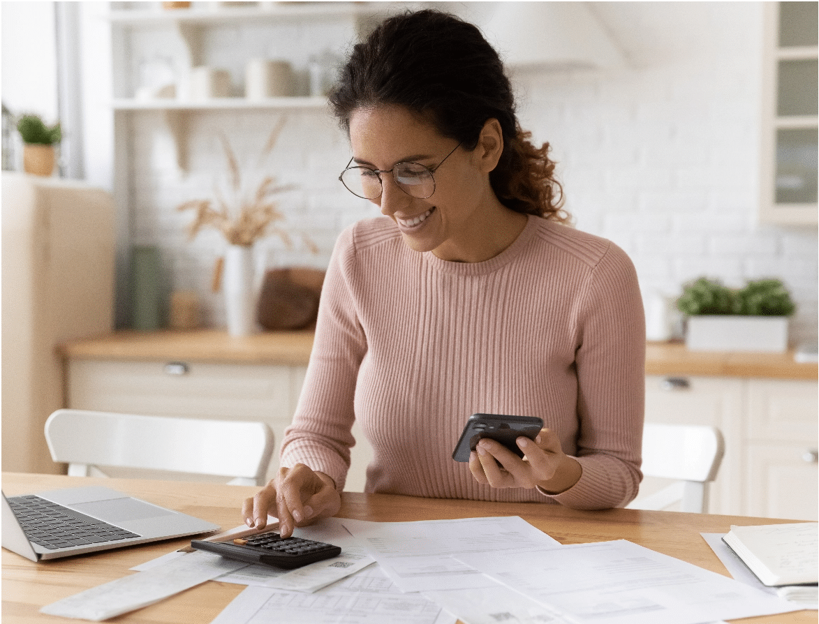 Person using calculator and cellphone